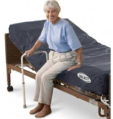 elderly woman sitting on a home hospital bed