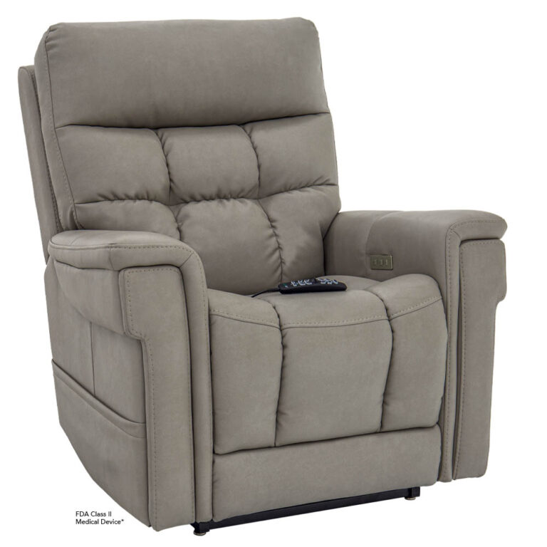 Gray upholstered power lift recliner chair with remote resting on the seat and a side pocket on the arm. FDA Class II medical device label visible.