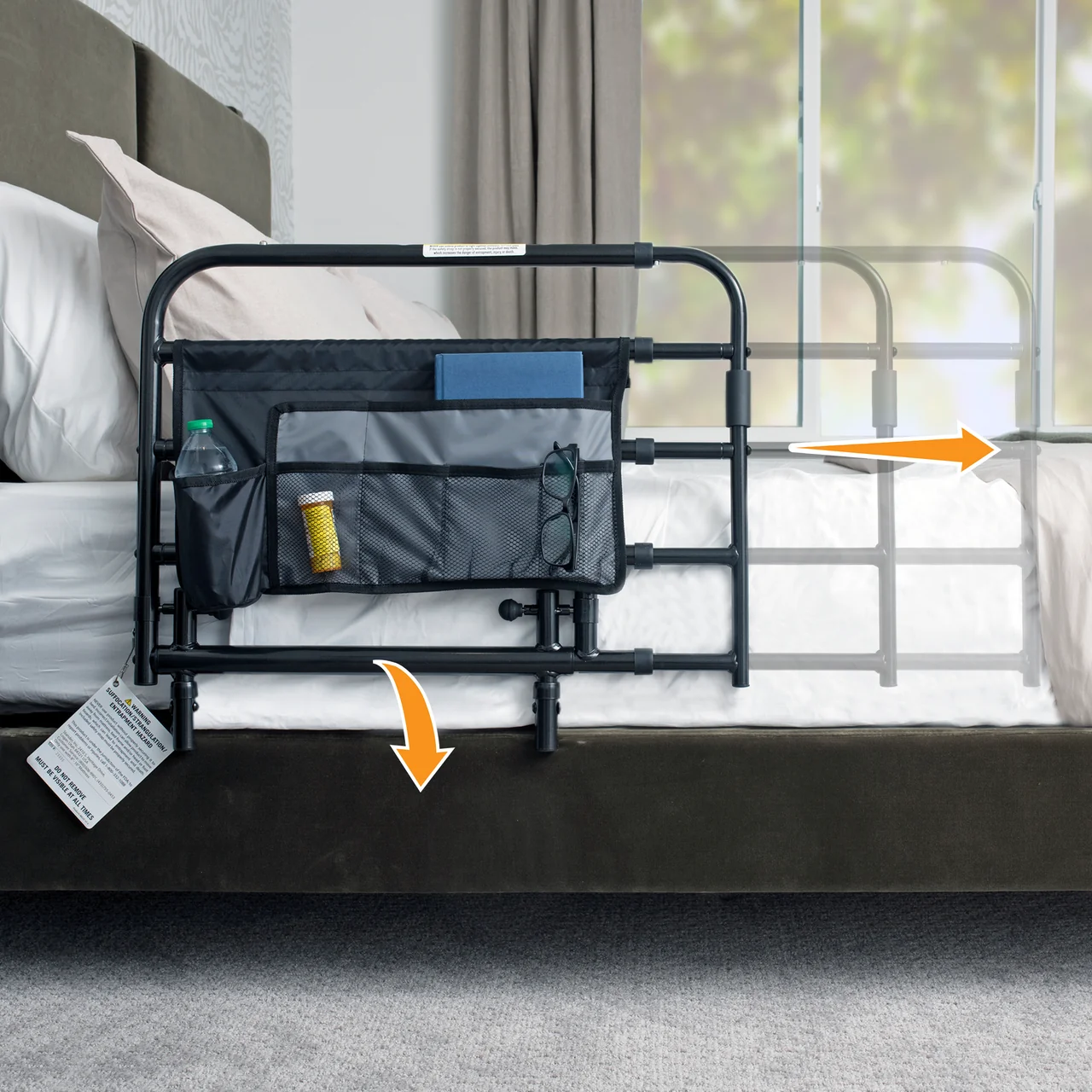 Pivot Bed Rails Hospital bed with a black side rail and a hanging storage pouch holding a water bottle, a pill bottle, and glasses.