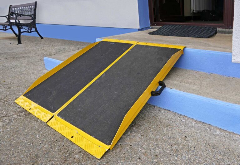 portable wheelchair ramp installed over small stairs